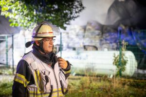 Ein Feuerwehrmann beim Einsatz in Mainz-Hechtsheim, im Hintergrund des Gastank. - Foto: Feuerwehr Mainz