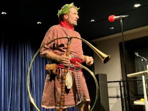 Musikalisch-römische Fastnacht: Rainer Müllers mit einem Cornu als Zeremonienmeister der Saturnalien. - Foto: gik