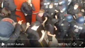 Polizisten drücken Demonstranten, die ihre Hände hoch erhoben haben, in eine Unterführung am Ingelheimer Bahnhof. Szene aus einem auf Twitter geteilten Video. – Screenshot: gik